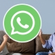 Men showing a WhatsApp Messenger icon