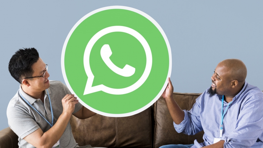 Men showing a WhatsApp Messenger icon